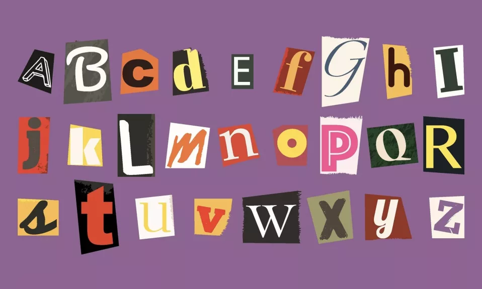 Colorful cut-out alphabet letters on purple background.